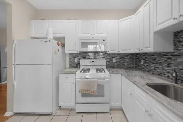 Kitchen with gas range and refrigerator