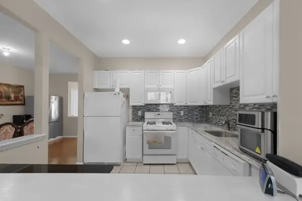 Kitchen with white cabinetry and tile floor