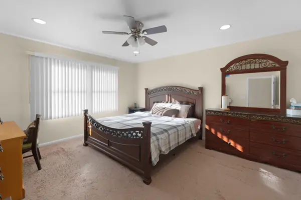 Primary bedroom with vaulted ceiling